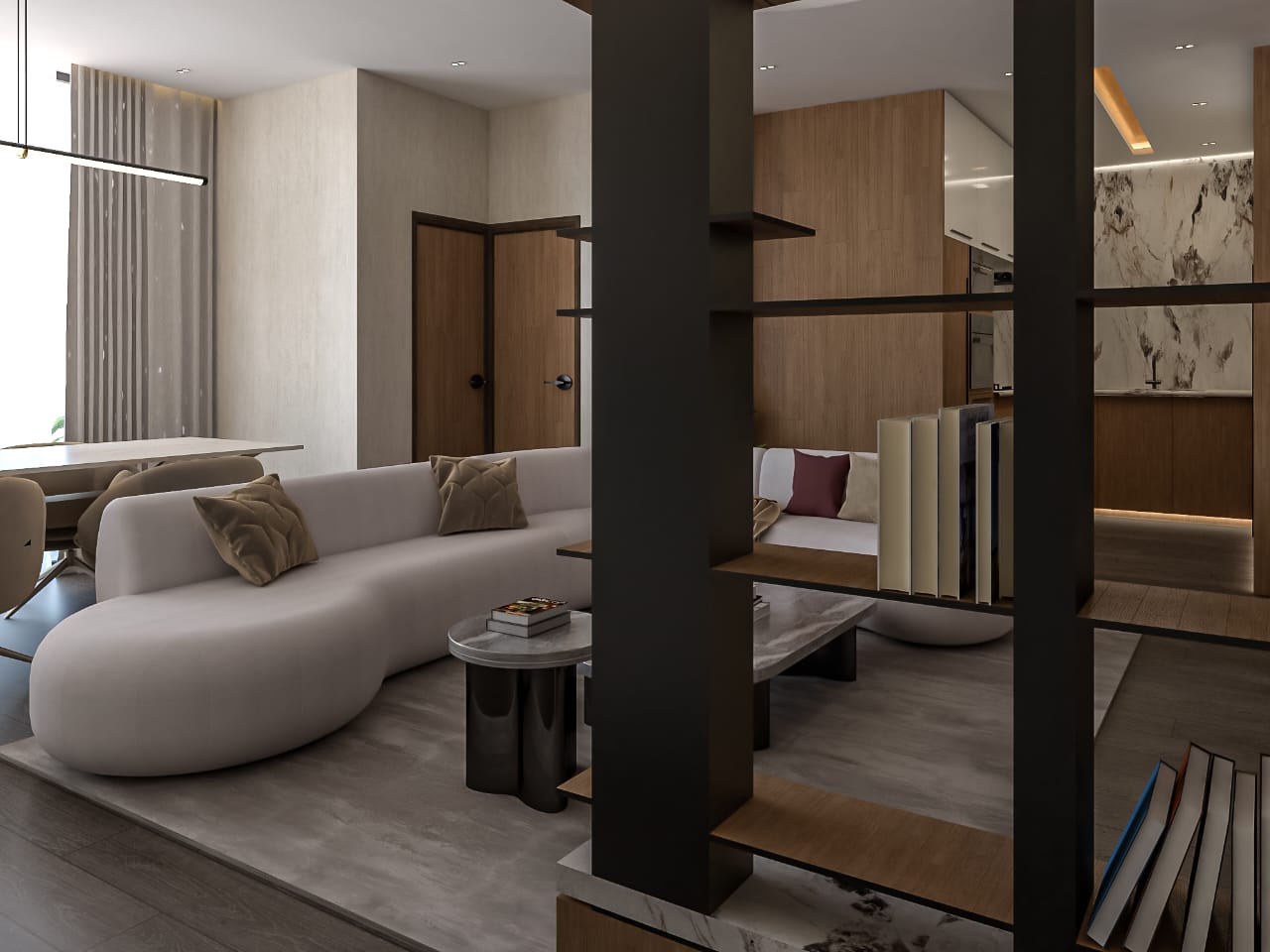 Modern open-concept living area with a white curved sofa, cushions, and a coffee table, adjacent to a dining area and kitchen.