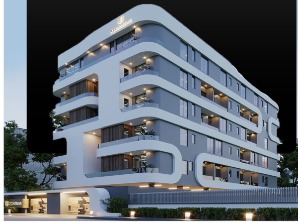 Modern, curved-white façade apartment building with multiple balconies and illuminated exterior lights at dusk.