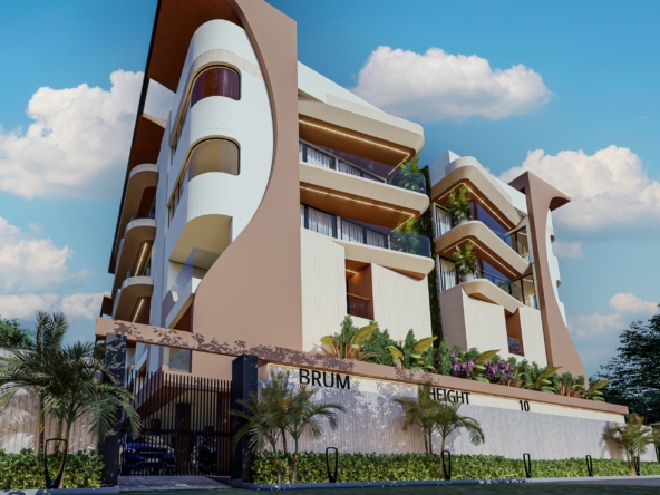 Modern multi-story apartment building with rounded balconies and a pink-beige facade under a clear blue sky.